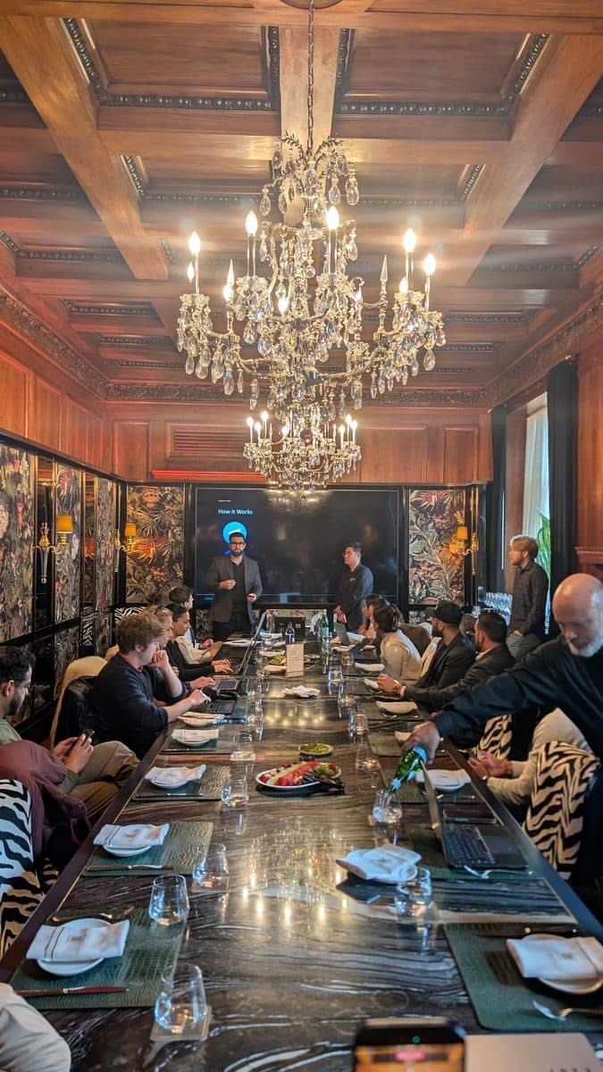 Small group dinner session around a chandelier-lit table